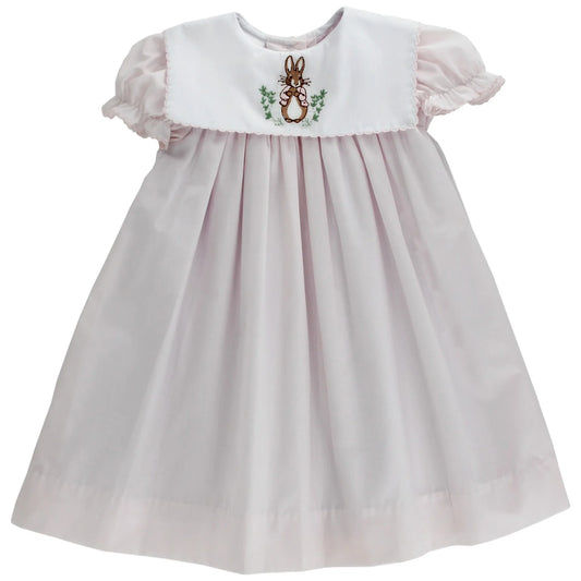 A pink baby float dress with bunny embroidery on the chest.